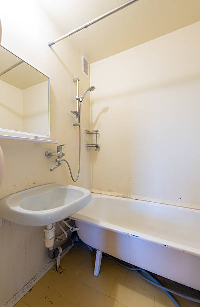 istock Compact Home Bathroom Interior with Basin, Bathtub, and Shower Fixtures 2245080710