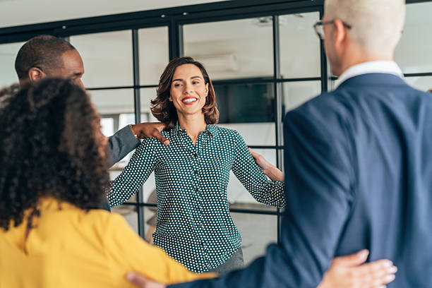 istock Cheerful team huddle in the office 2245084374