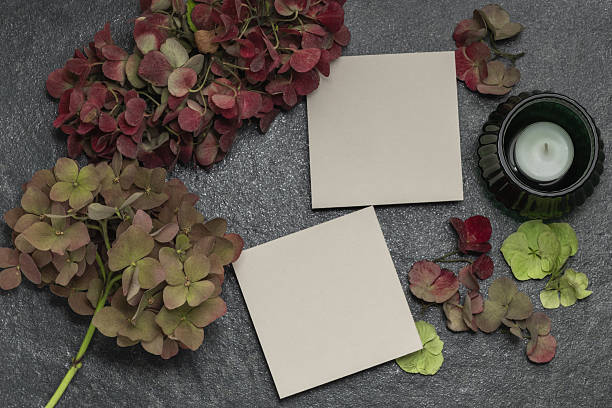 istock Blank cards on a dark gray background. Invitation or greeting card concept with hydrangea branches and a candle. 2245084792