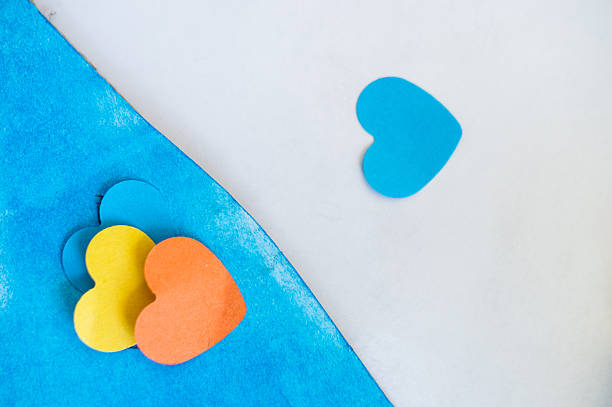 istock Hearts of various colors on a blue and white background with copyspace 2245084867