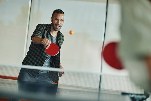 istock Happy man enjoying while playing table tennis. 2245085580