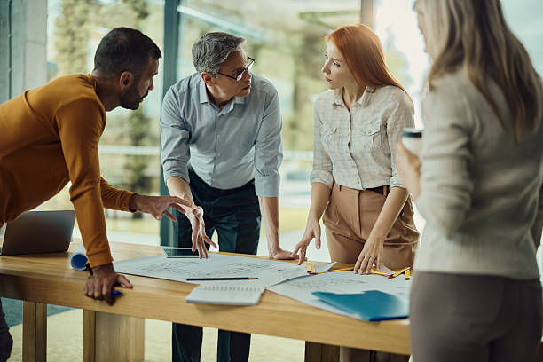 istock Building contractors working on plans in the office. 2245085696
