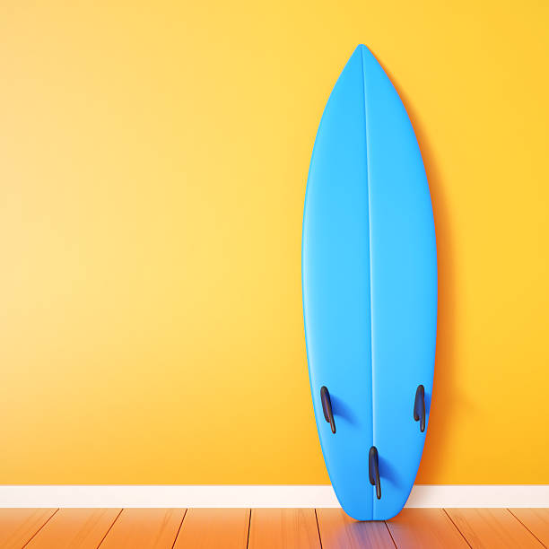 istock Blue surfboard near orange wall with place for text 2245085875