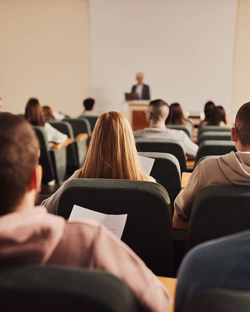 istock Rear view of large group of students on a class at lecture hall. 2245087155