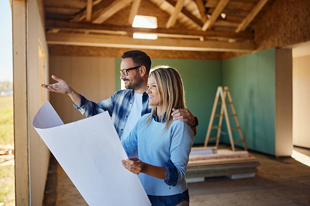 istock Happy couple making plans of their developing house. 2245087664