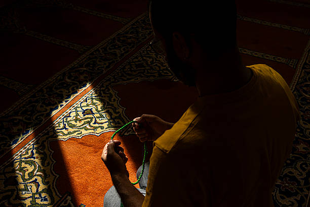 istock Muslim man praying with prayer beads in mosque 2245090945