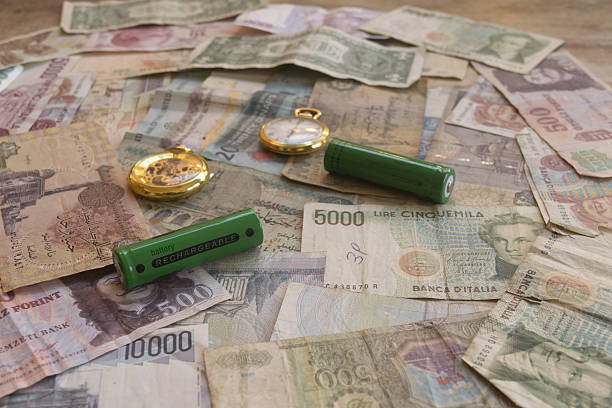 istock rechargeable batteries on vintage international currency banknotes 2245090969