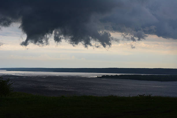 Wide angle view of the Sacramento River, with storm clouds in the background.Taken in Sacramento, California, USA
