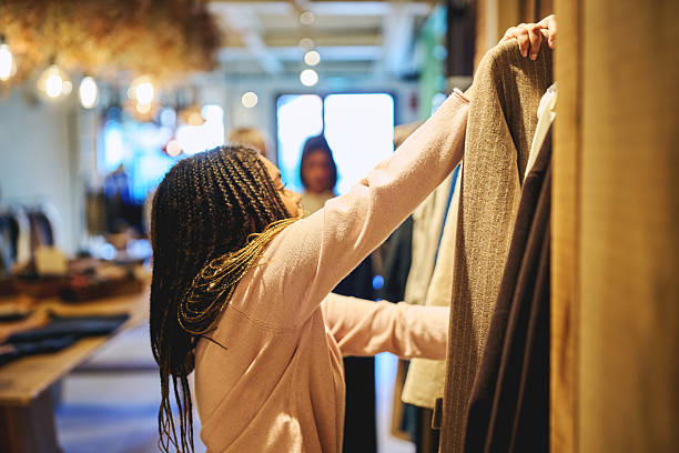 istock Young woman browsing clothes on rack inside stylish independent boutique 2245096254