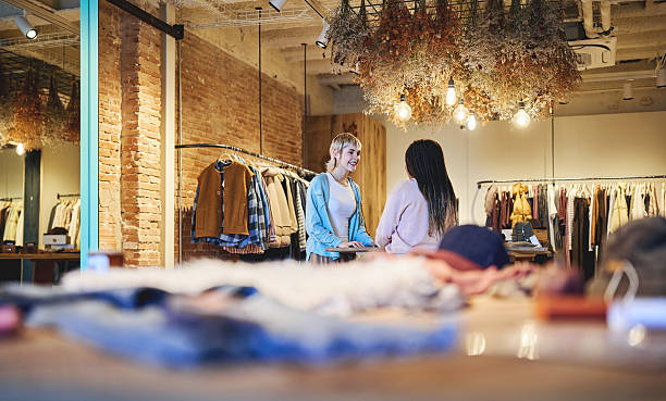 istock Conversation between friends inside stylish boutique clothing store 2245096270