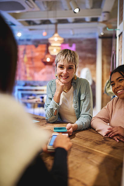 istock Happy customers chatting with shop assistant at boutique counter 2245096282