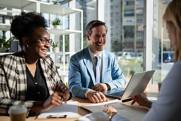 istock Diverse business people laughing during office meeting 2245097173