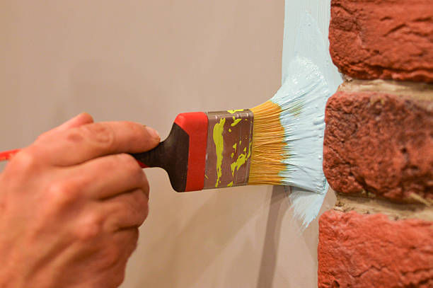 istock Painting a Wall with Brush and Blue Paint. 2245099021