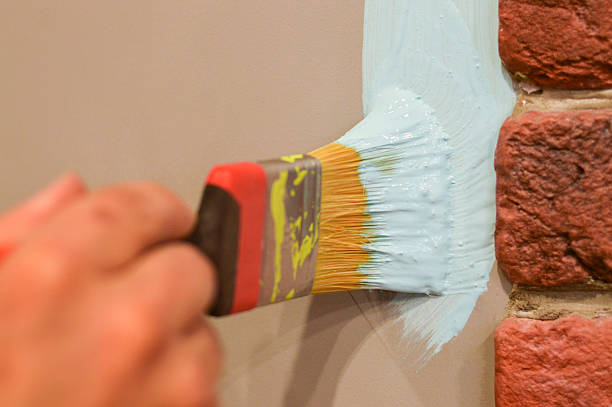 istock Painting a Wall with Brush and Blue Paint. 2245099186