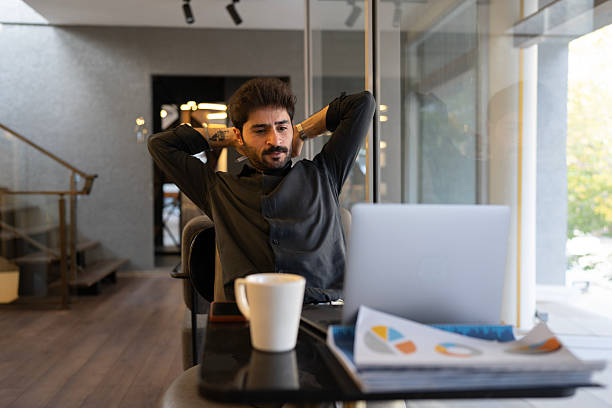 istock Businessman relaxing at desk, taking a work break 2245099476