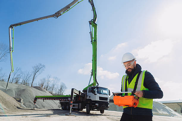 istock Construction worker operating concrete pump truck at plant 2245099608