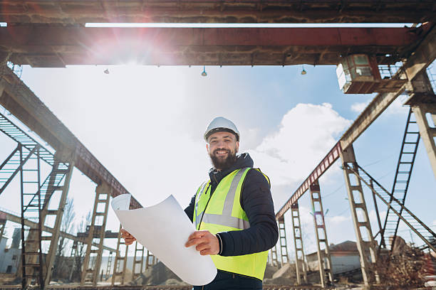 istock Construction engineer holding blueprints at concrete production plant 2245100256