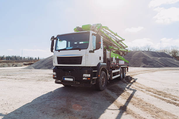 istock Concrete pump truck parked at construction site on sunny day 2245100296
