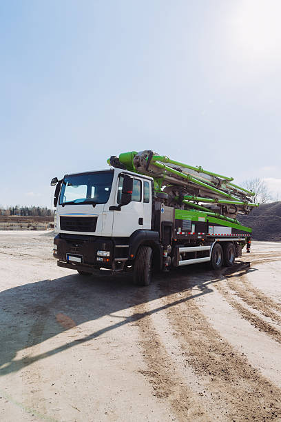 istock Concrete pump truck parked at construction site on sunny day 2245100305