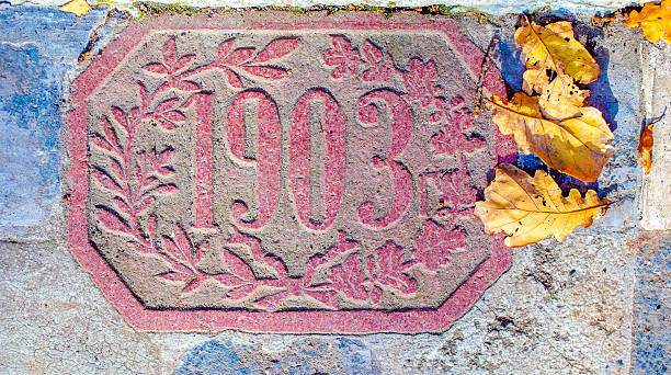 istock Antique date engraving on stone tiles with floral pattern 2245100579
