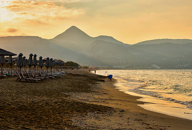 istock Nice and peaceful sunset over beach, Cretan sea and mountain on horizon. 2245100625
