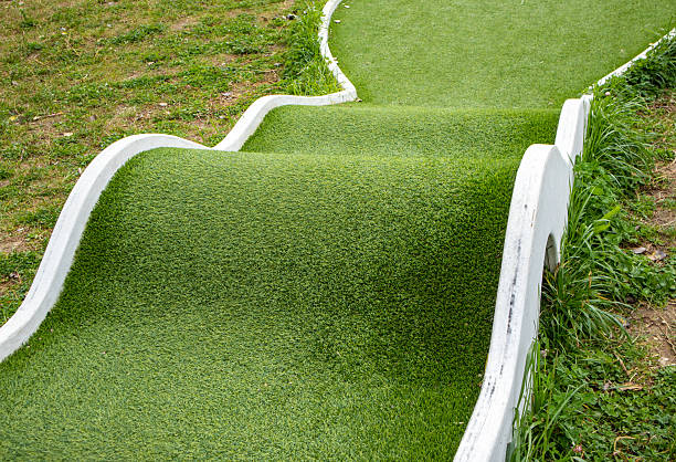 Somebody is playing minigolf with a red ball. Mini golf recreation. High quality photo