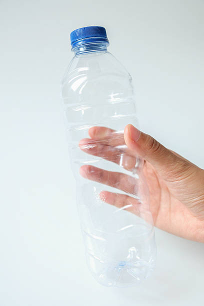 istock Hands holding plastic mineral water bottle trash on white background 2245103326