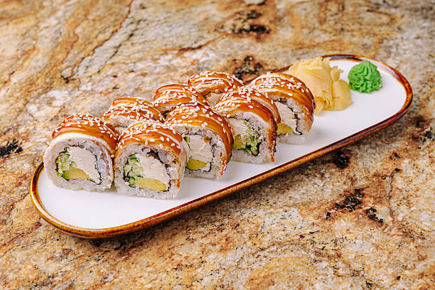 istock Sushi rolls served on a plate with ginger and wasabi on a textured table 2245106050