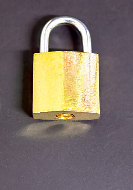 istock A bronze-colored lock and a key next to it on a black background, a security concept, as well as a concept of cybersecurity and data protection, with empty space for text 2245107276