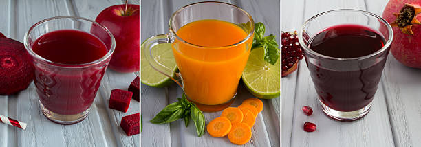 Collage of different juices in the drinking glasses on the gray wooden background. Close-up.