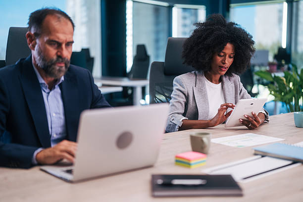 istock Diverse business professionals working on laptop and digital tablet in office 2245108496