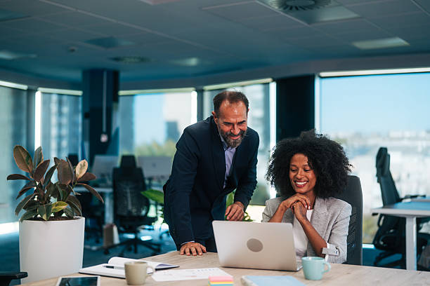 istock Business professionals collaborating on laptop in modern office 2245108554