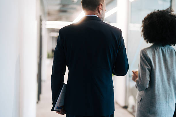 istock Business colleagues walking through office hallway during workday 2245108793