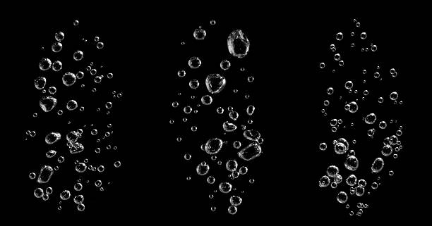 istock Three streams of air bubbles rising underwater against a black background, perfect for refreshing beverage ads, clean water concepts, and digital visual effects in motion design. 2245108904