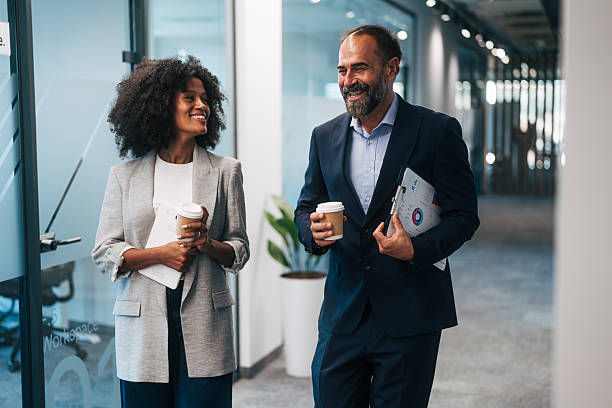 istock Business colleagues walking and talking during coffee break 2245108987