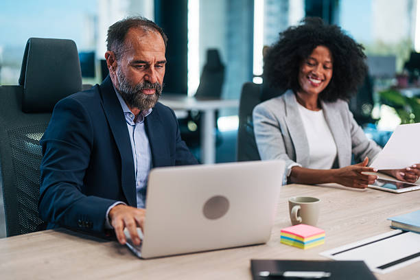 istock Business colleagues collaborating in modern office workspace 2245109230