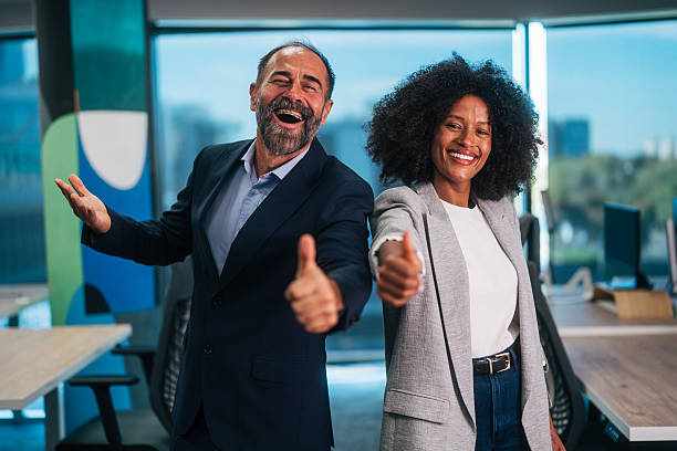 istock Diverse business partners showing thumbs up in modern office 2245109655