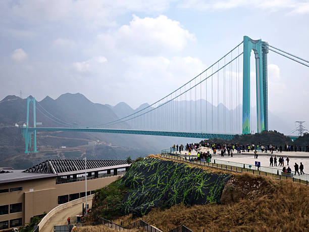 Tourists sightseeing at the View point of Huajiang Canyon Bridge, a suspension bridge in Guizhou, China. The bridge crosses the Beipan River and as is the world's highest bridge, measuring 625 metres from the bridge deck to the bottom of the gorge.