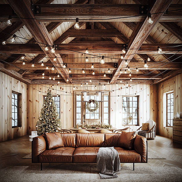 istock Cozy rustic living room decorated for Christmas with warm string lights, a beautifully adorned Christmas tree, and elegant holiday wreath. 2245110258
