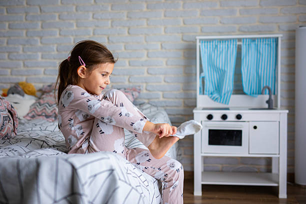 istock Little Girl Dressing Herself at Home 2245111094