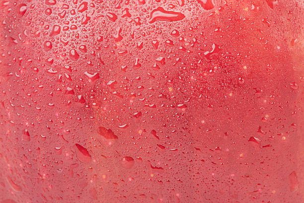 istock Texture of red apple with drops as background. 2245113387
