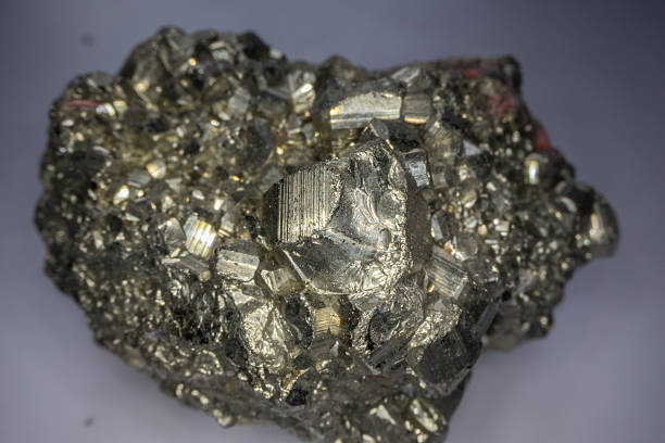 istock golden Pyrite crystals in close-up 2245113946