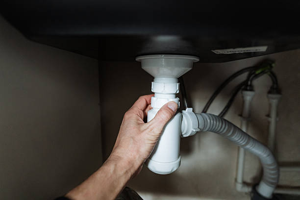 istock A skilled person is diligently fixing a sink pipe located under the kitchen sink, ensuring everything functions properly and adheres to plumbing standards for optimal cleanliness 2245114164