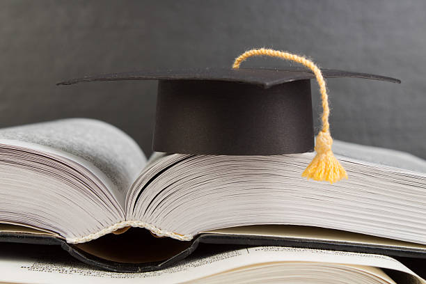 istock Open book on wooden deck table and black board background. Back to School. Education concept with copy space for your ad text. 2245115517