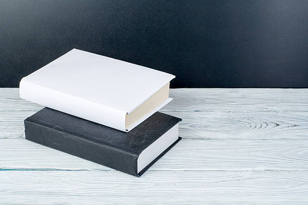 istock Hardback books on wooden table, white background. Back to school. Copy space for text. Education business concept. 2245115666
