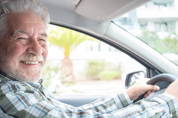 istock Happy senior man driving a car and smiling confidently. Elderly bearded man representing independence, active aging, and lifestyle freedom 2245115677