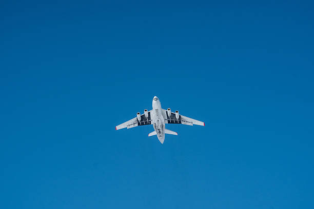 istock A bright white airplane is soaring gracefully through a beautifully clear blue sky on a lovely, sunny day, showcasing the wonders of aviation and air travel. Its a magnificent sight 2245115782