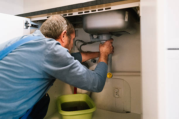 istock A plumber repairs a blocked drain in a kitchen 2245117261