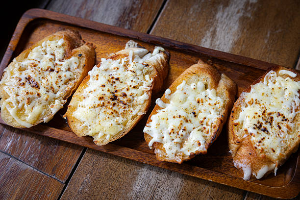 Cheesy garlic bread served for breakfast on cafe table.