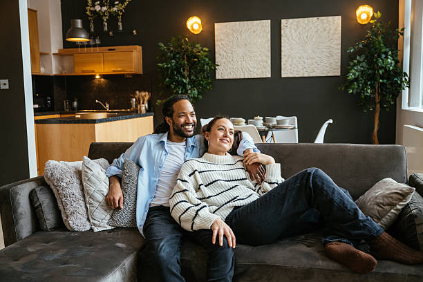 istock Heterosexual multiethnic couple at home enjoying evening and drinking coffee or tea while enjoying the view 2245119288